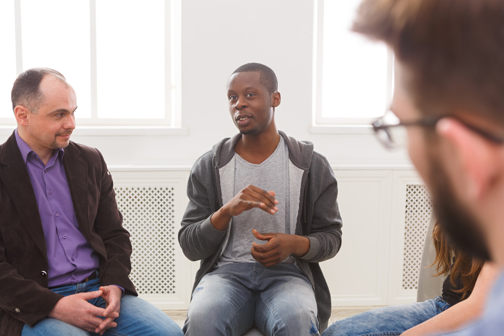 In a support group meeting, a man discusses his life, shares his problems and issues, emphasizing the importance of mental health and psychotherapy.