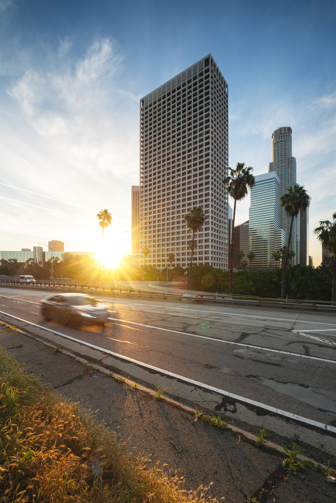 Los Angeles downtown with highway and moving car. Sunrise in LA financial district