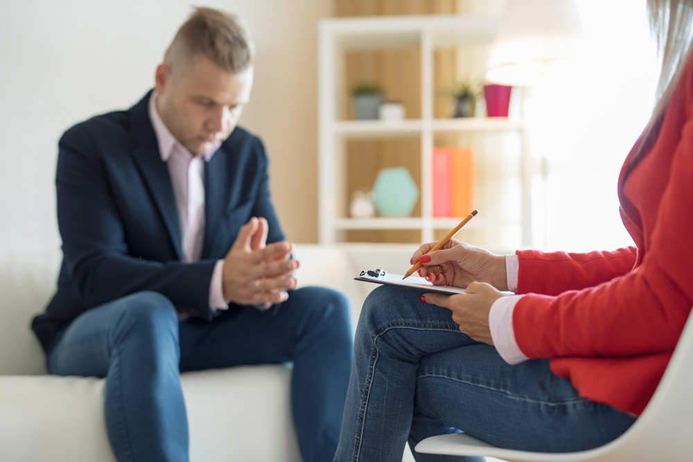 Man at consultation with psychiatrist during rehap therapy