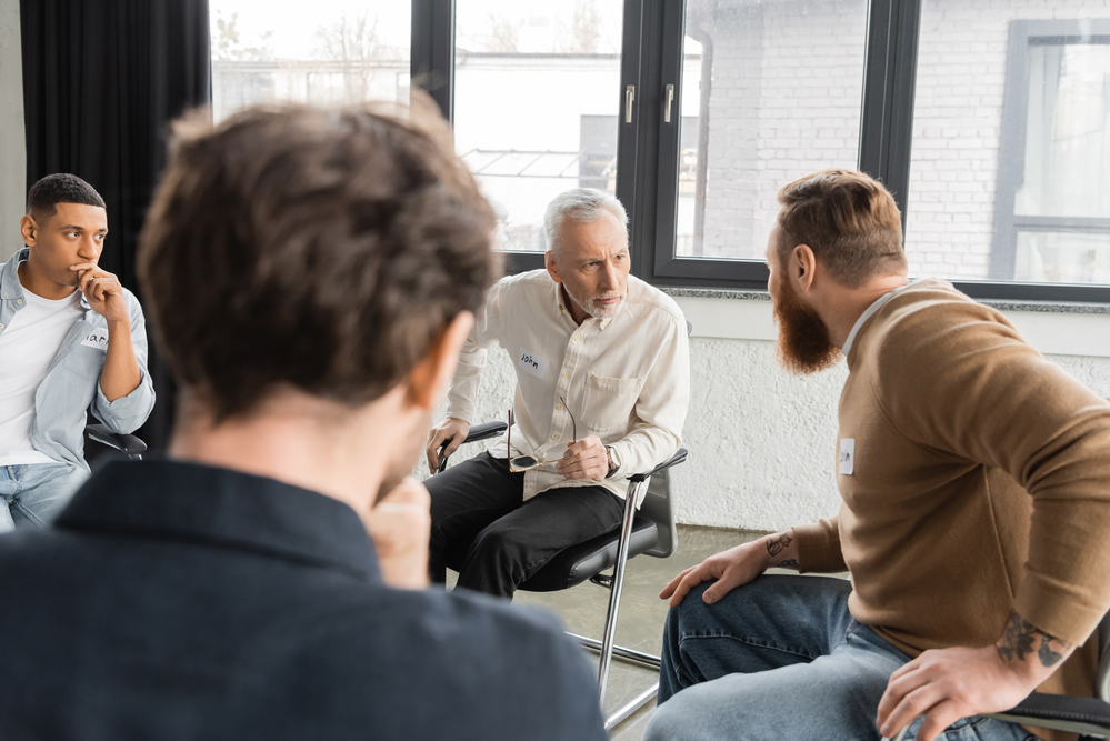 Psychotherapist working with patients in group therapy session
