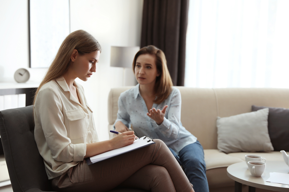 Professional rehab psychotherapist working with patient in office