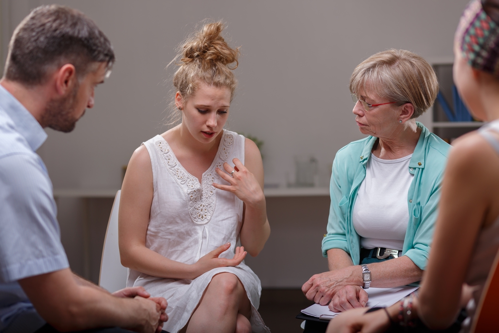 Young woman participating in group rehab therapy session