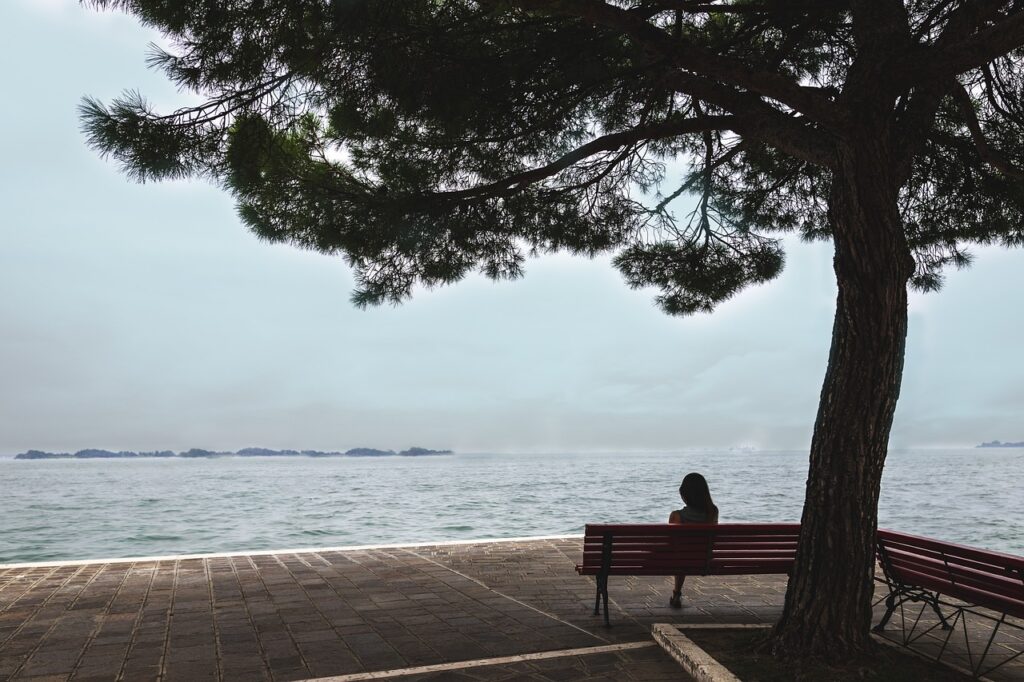 what is inpatient drug rehab, woman sitting on bench near water