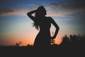 silhouette posing in front of sunset